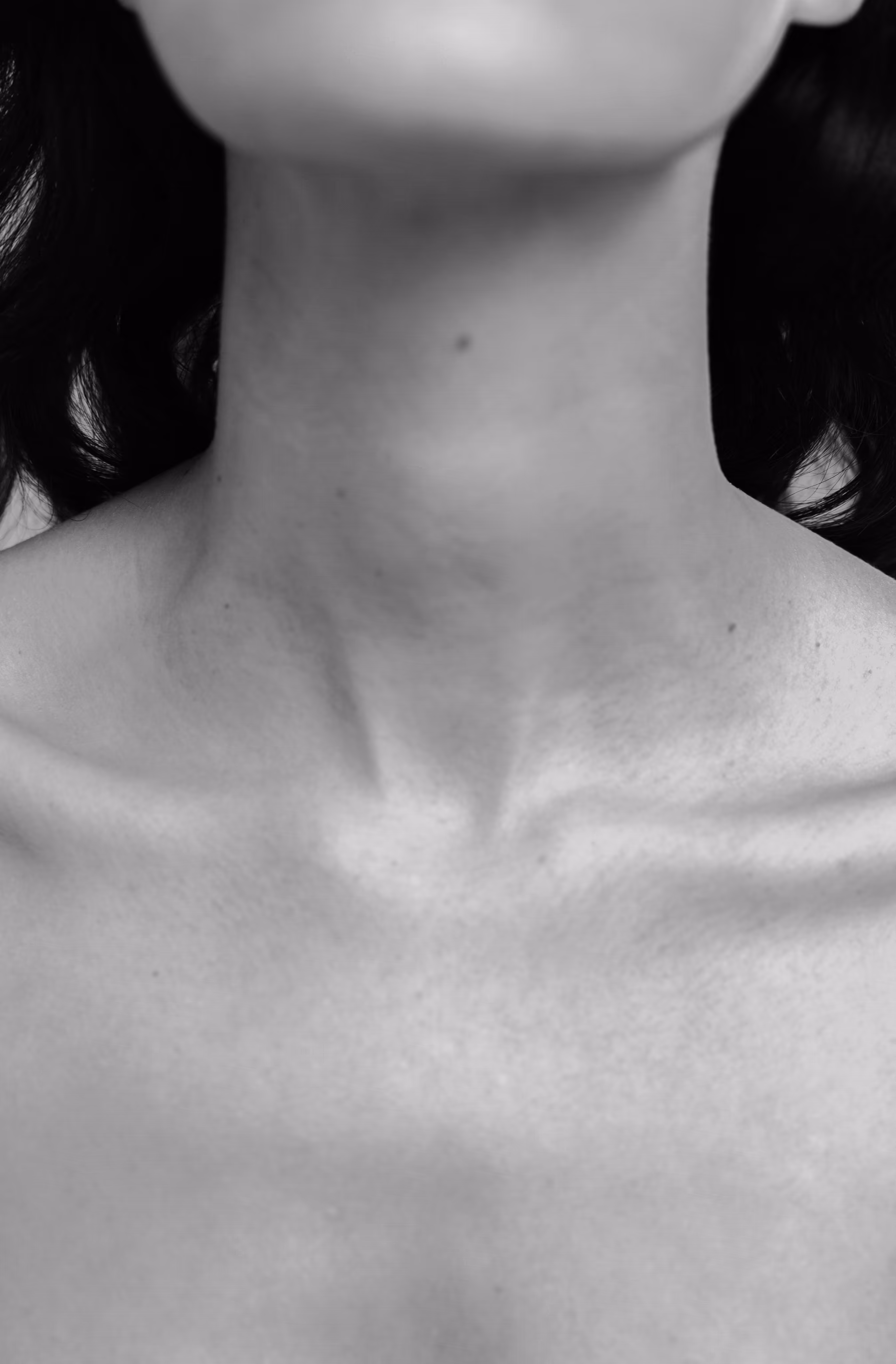 Soft close-up of a woman's neck and shoulder